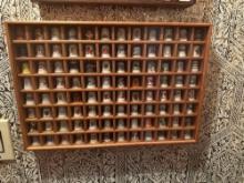 Collection of thimbles in cabinet.