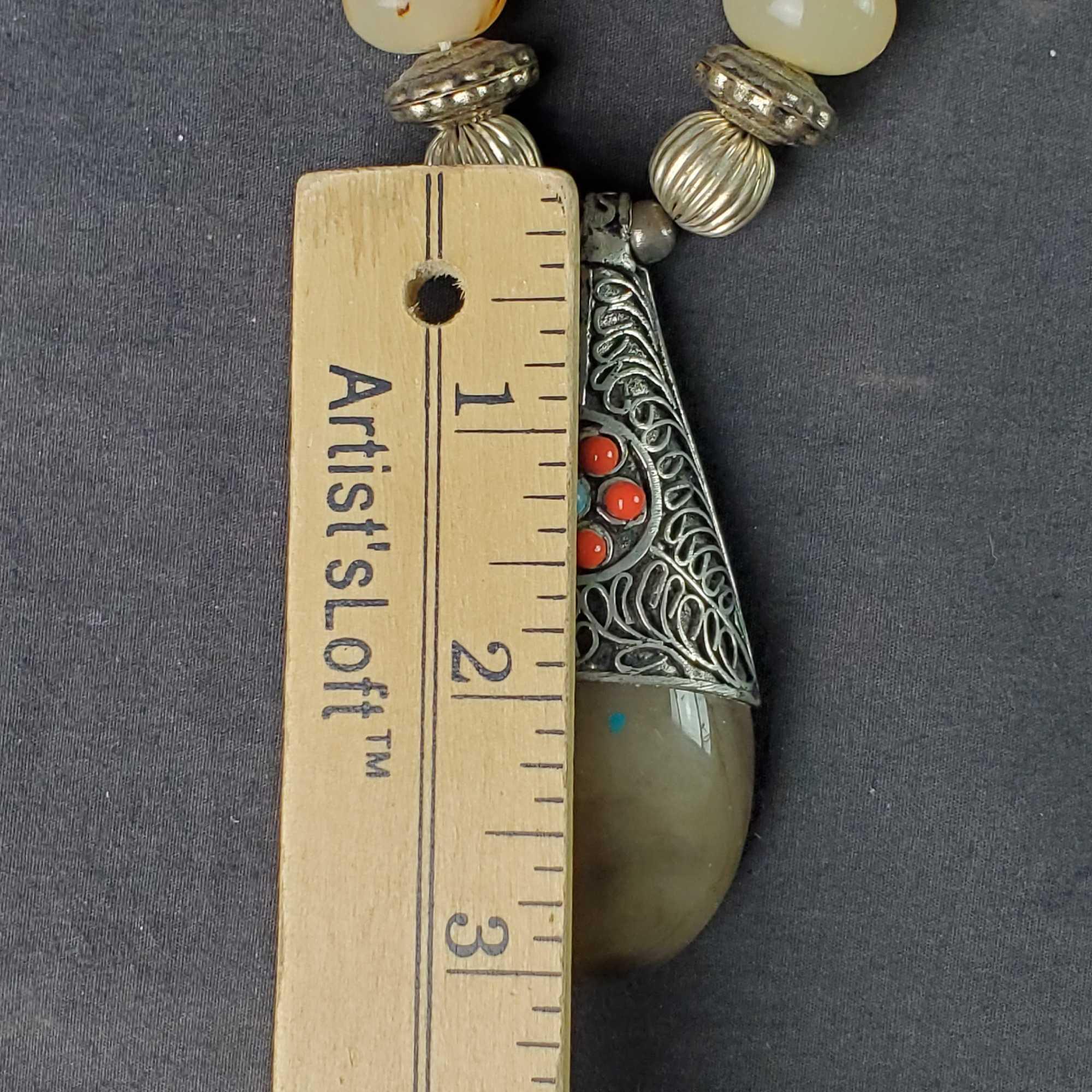 Unique beaded and shell disc necklace with large stone like pendant