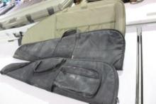 Three soft sided rifle cases. One green nylon AR case, like new and two black nylon cases, used.