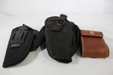 Two black nylon right handed holsters, one belt and one leg and one brown leather flip-open belt