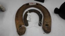 horseshoes, one standard size and one small poney shoe