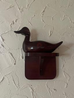 wooden duck clock and more on wall in living room