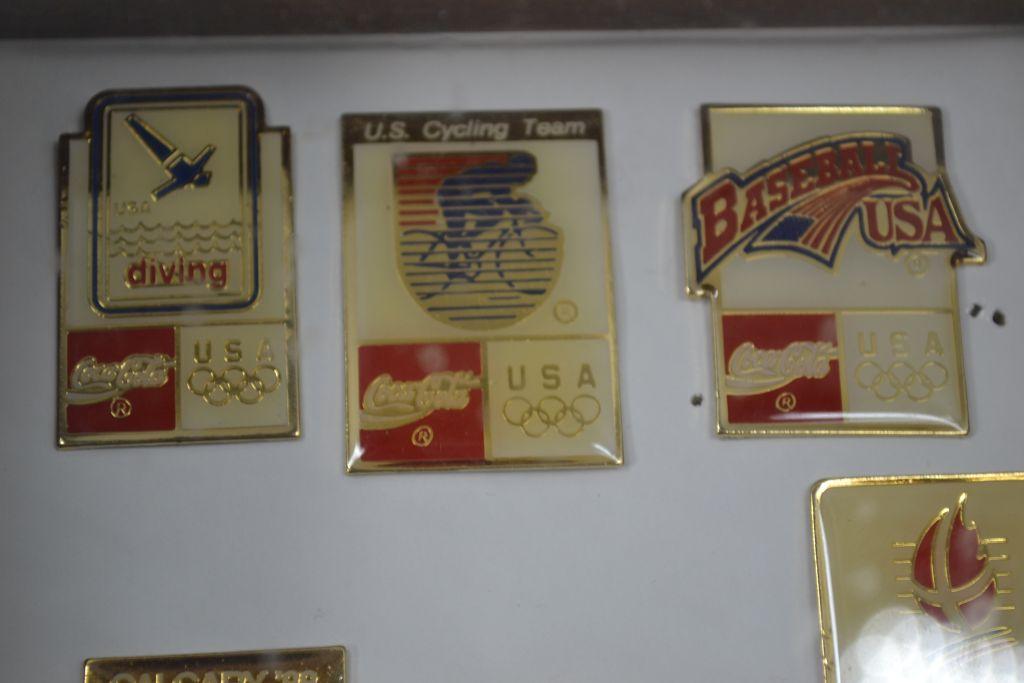 Group of Olympic Coca-Cola Pins Collection Containing Years 52, 68, 72, 82, 88, 92; In Mounted Shado