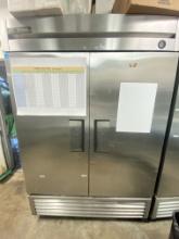 True model T 49 two-door stainless steel refrigerator mounted on casters with six adjustable epoxy c