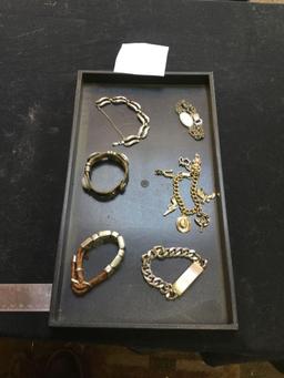 Group of various bracelets, including charm bracelet