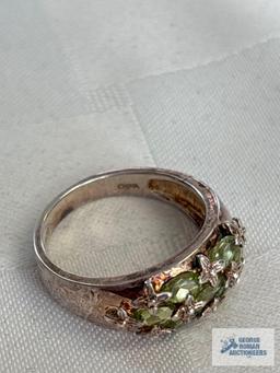 Silver colored ring with green gemstones, marked 925, approximate total weight is 5.4 G
