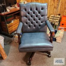 Faux leather roll about executive office chair in basement