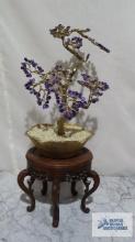 Purple stone and gold colored metal tree in planter on wooden base. approximately 12 in. tall.