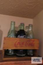Coca Cola bottles in small crate
