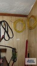 Jumper cables, Romex, extendable light bulb changer, shovel and etc on pegboard