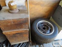 Assorted tires with rims and vintage box with chemical jugs