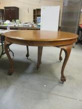 Vintage Round Wood Dining Table with Claw Feet and Wheels