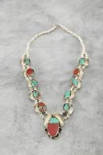 "Navajo" marked silver, turquoise and coral Necklace with engraved feathers surrounding stone. Naja