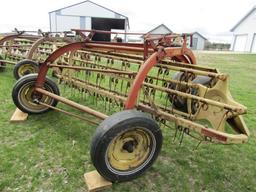 147. NEW HOLLAND 256 9 FT. PARALLEL BAR RAKE WITH HITCH WHEEL