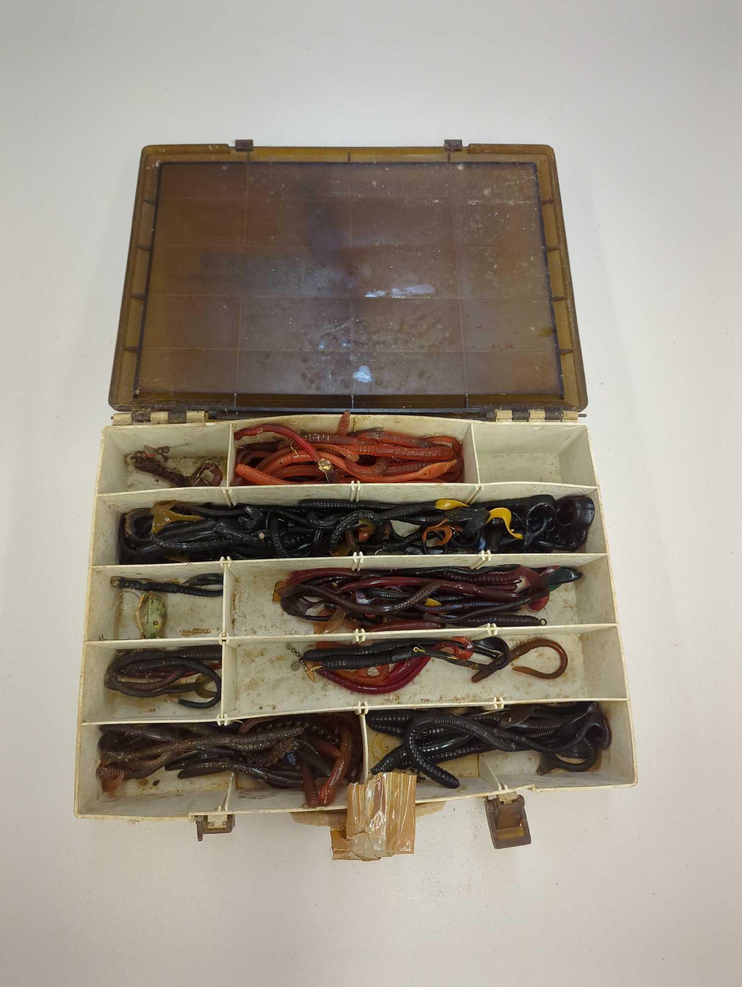 Tackle Box and contents includes various styles of worms and other fishing lures. Comes as is shown