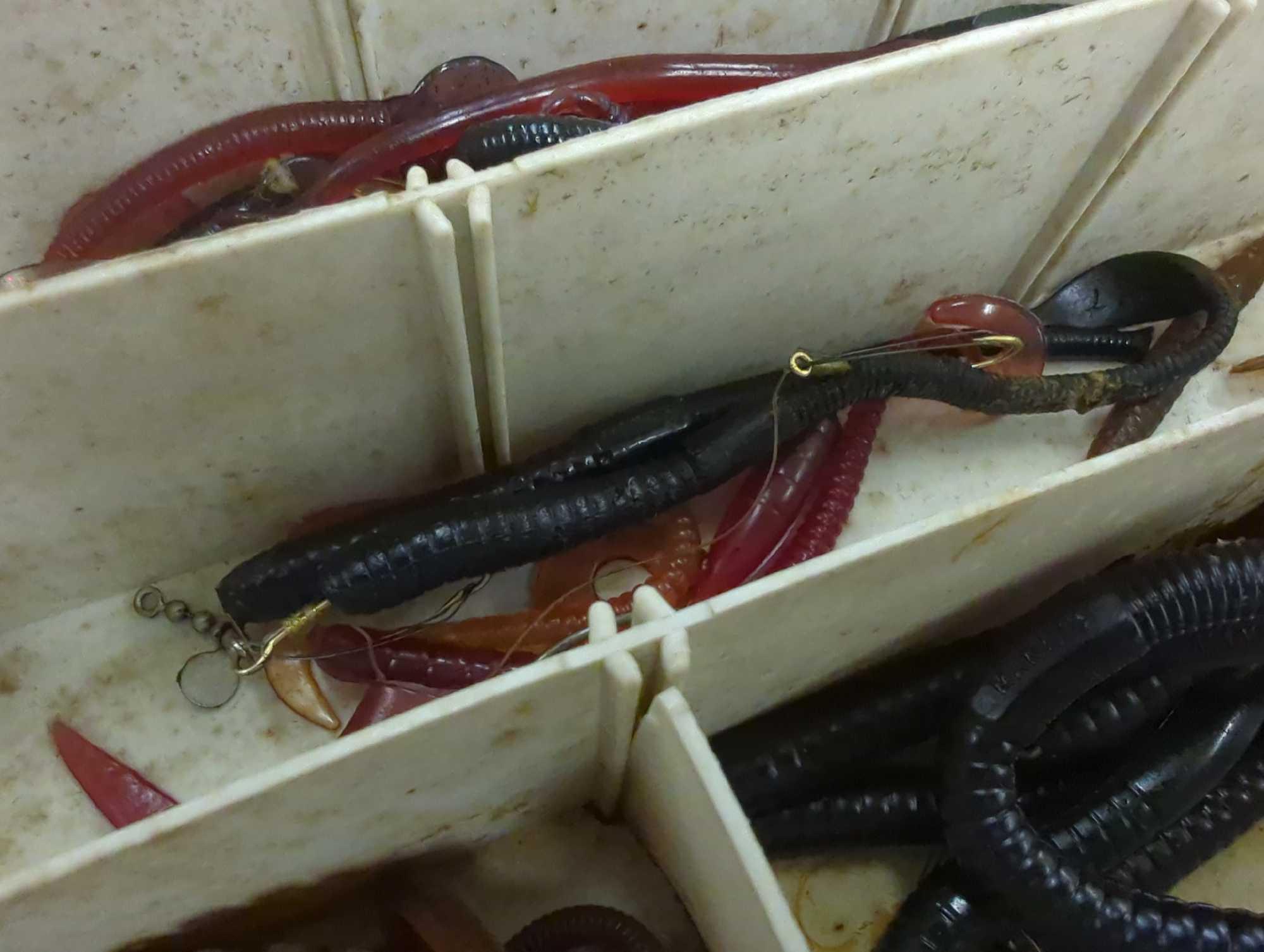 Tackle Box and contents includes various styles of worms and other fishing lures. Comes as is shown
