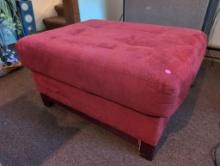 (DEN) STRATFORD COMPANY RED UPHOLSTERED OTTOMAN WITH WOOD LEG BASE. MEASURES 37"W X 27-1/2"D X