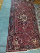 (DEN) ORIENTAL STYLE MULTI-COLORED AREA RUG WITH REDS AND BLUES, APPROXIMATE DIMENSIONS - 7'10" L X