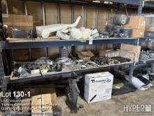 Truck parts on pallet rack including washer fluid containers, hose , air bags , shocks , hangers , f