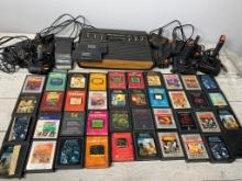 Vintage Atari 2600 Gaming Console Grouping with Controllers and Many Games