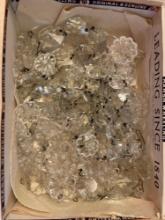Cigar box full of lamp crystals, some flower shaped