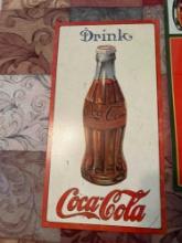 Two tin Coca-Cola signs with 1915 bottle and 1923 bottle
