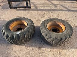 2 USED 15-19.5 TIRES W/RIMS TO FIT SKID STEER