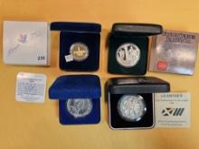 Four mixed World Commemorative pieces