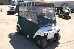 Green and white Club Car golf cart