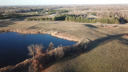 16.48 +/- Acres of wooded and open land with pond views