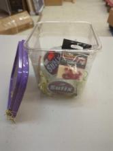 Small container and contents including fishing lines and other fishing accessories. Comes as is